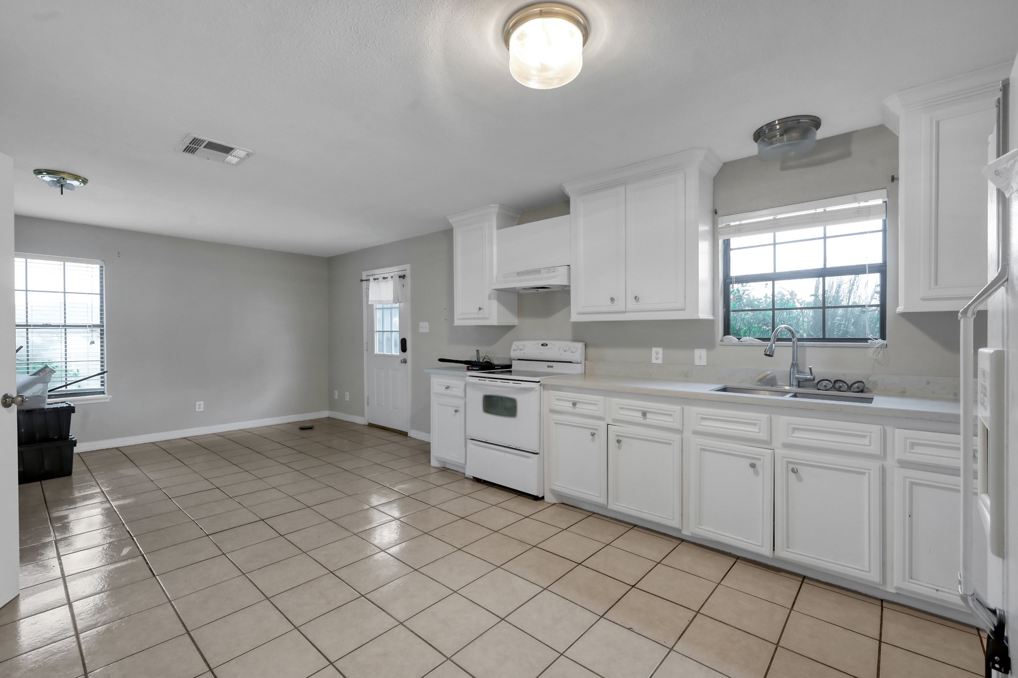 7644 Spring Cypress Road Spring, TX 77379 - Photo 16 of 28 a large white kitchen with a sink and cabinets