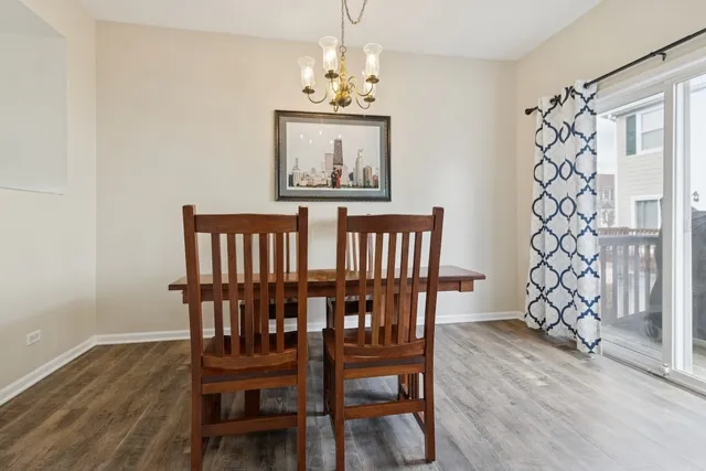 a view of a dining room with furniture wooden floor and chandelier
