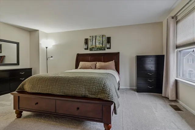 a bedroom with a bed and a night stand