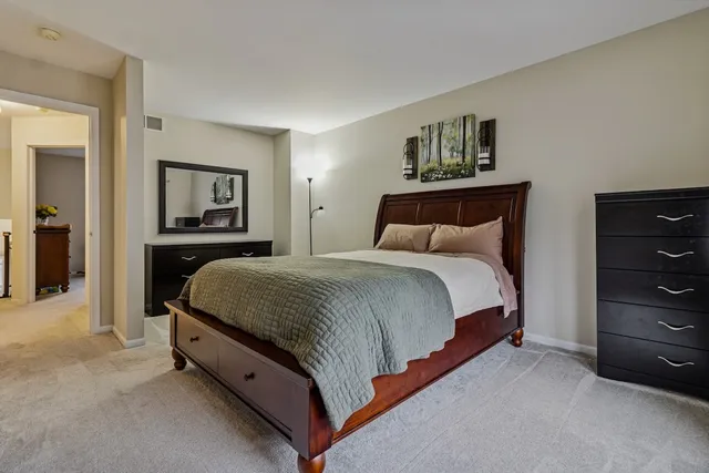 a bedroom with a bed and a dresser