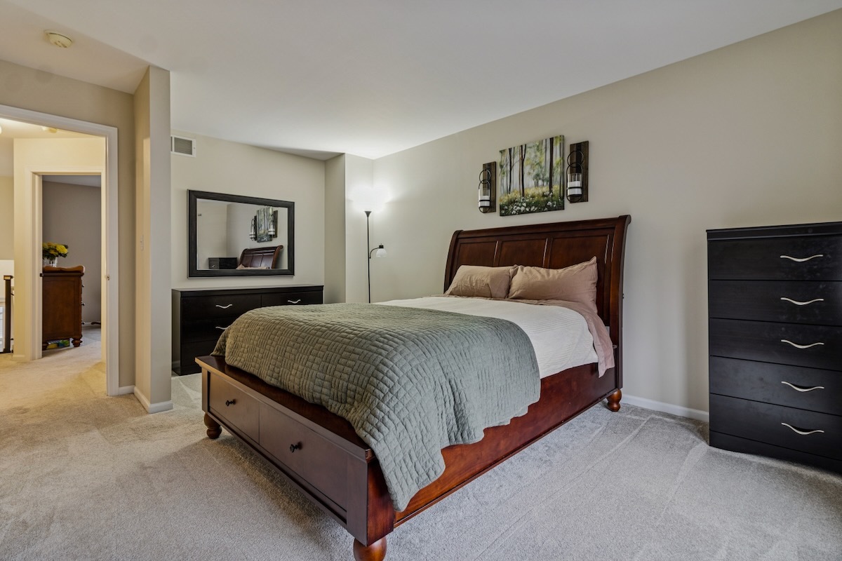2416 Courtyard Circle, Unit 2 Aurora, IL 60506 - Photo 14 of 22 a bedroom with a bed and a dresser