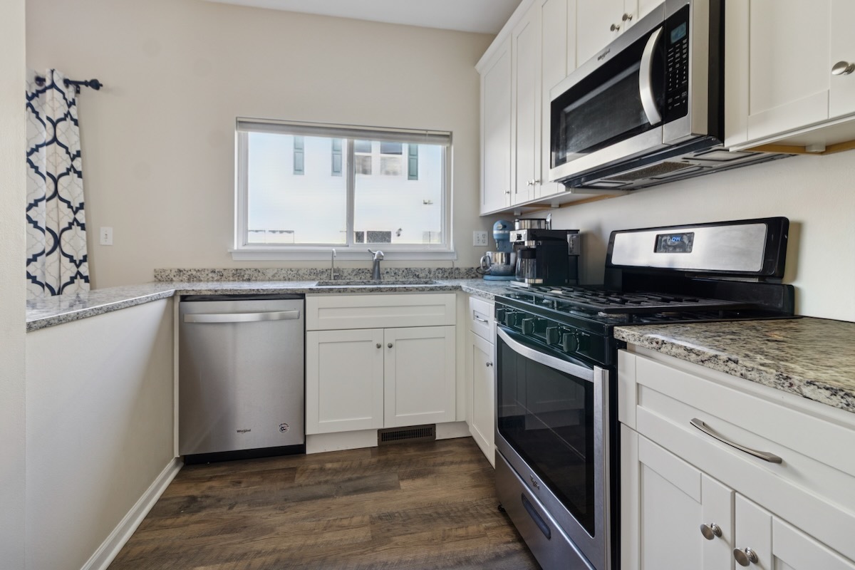 2416 Courtyard Circle, Unit 2 Aurora, IL 60506 - Photo 8 of 22 a kitchen with stainless steel appliances granite countertop a stove microwave and sink