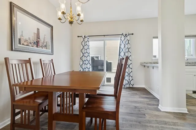 a view of a dining room with furniture wooden floor and a chandelier