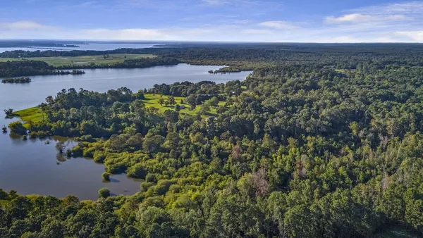 an aerial view of a houses with a lake view