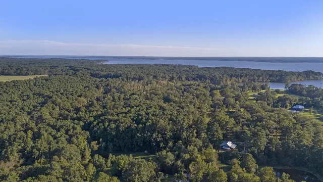an aerial view of a houses with a lake view