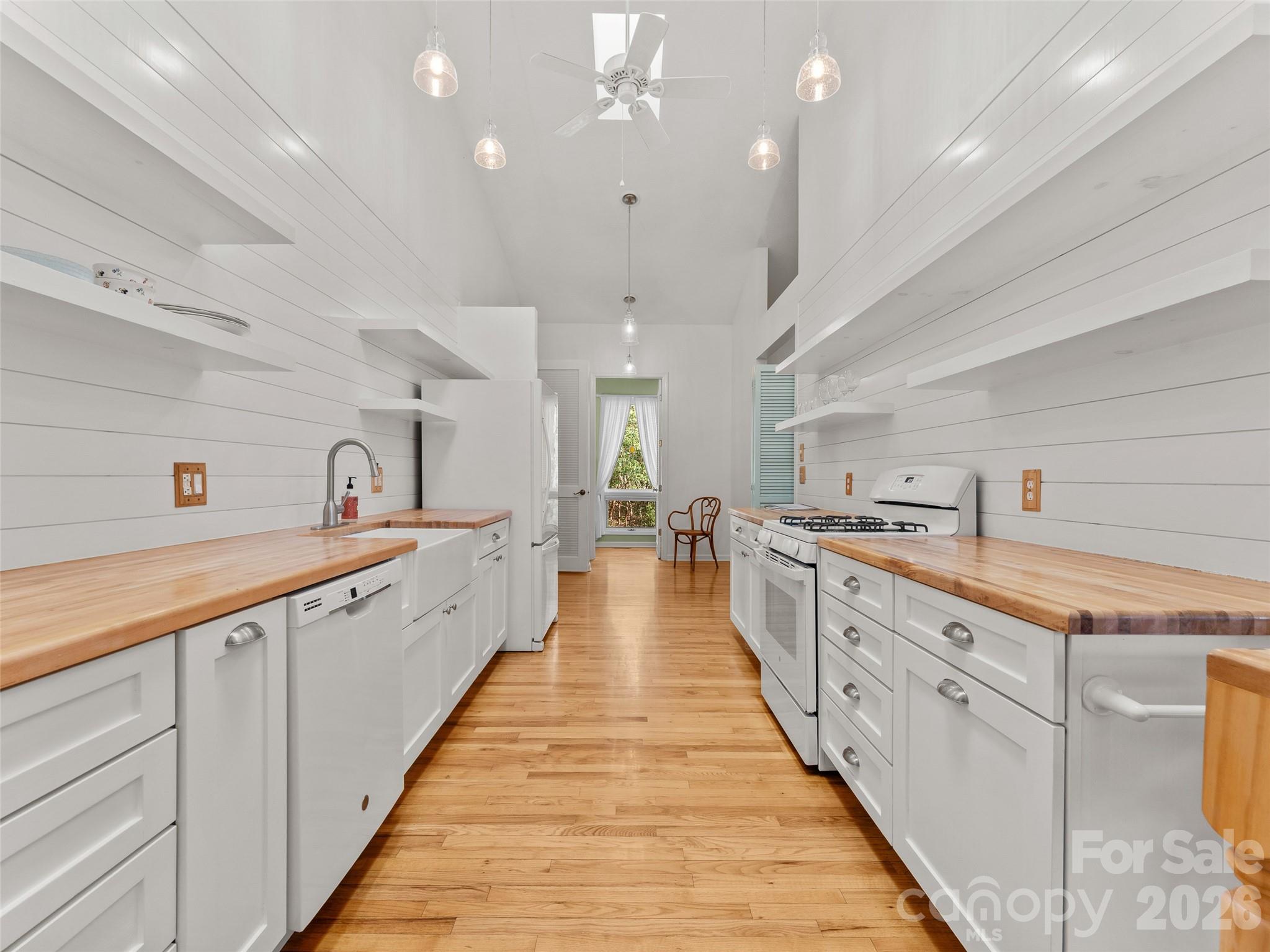 203 Heathcote Road Hendersonville, NC 28791 - Photo 11 of 47 a large kitchen with stainless steel appliances lots of counter space and wooden floor