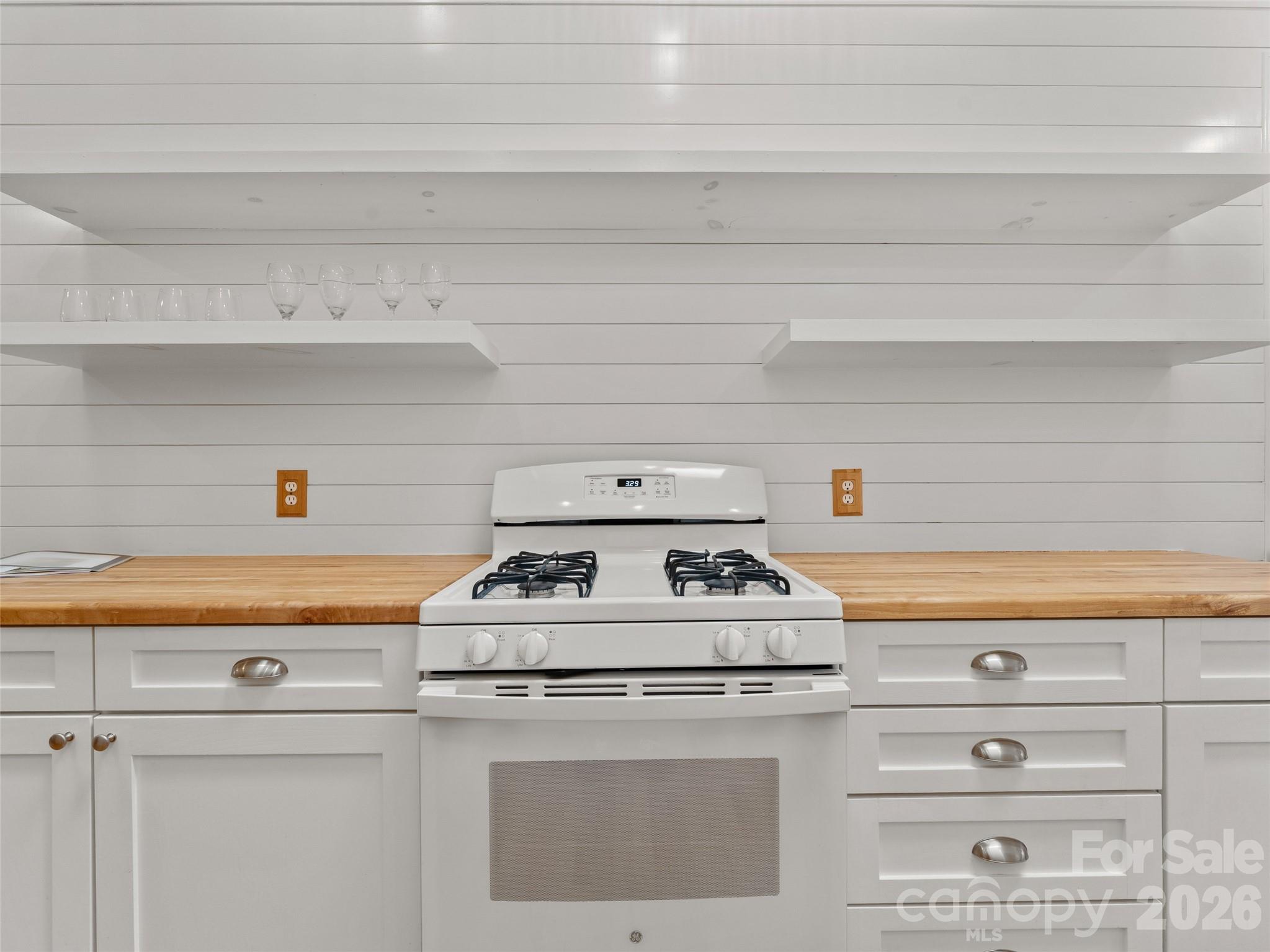 203 Heathcote Road Hendersonville, NC 28791 - Photo 15 of 47 a white stove top oven sitting inside of a kitchen