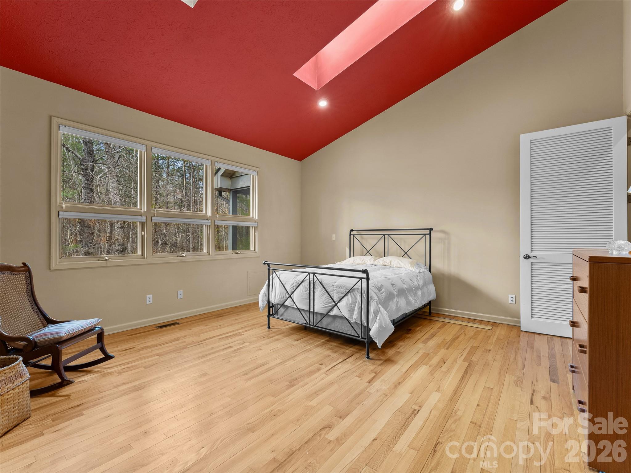 203 Heathcote Road Hendersonville, NC 28791 - Photo 17 of 47 a bedroom with a bed and wooden floor