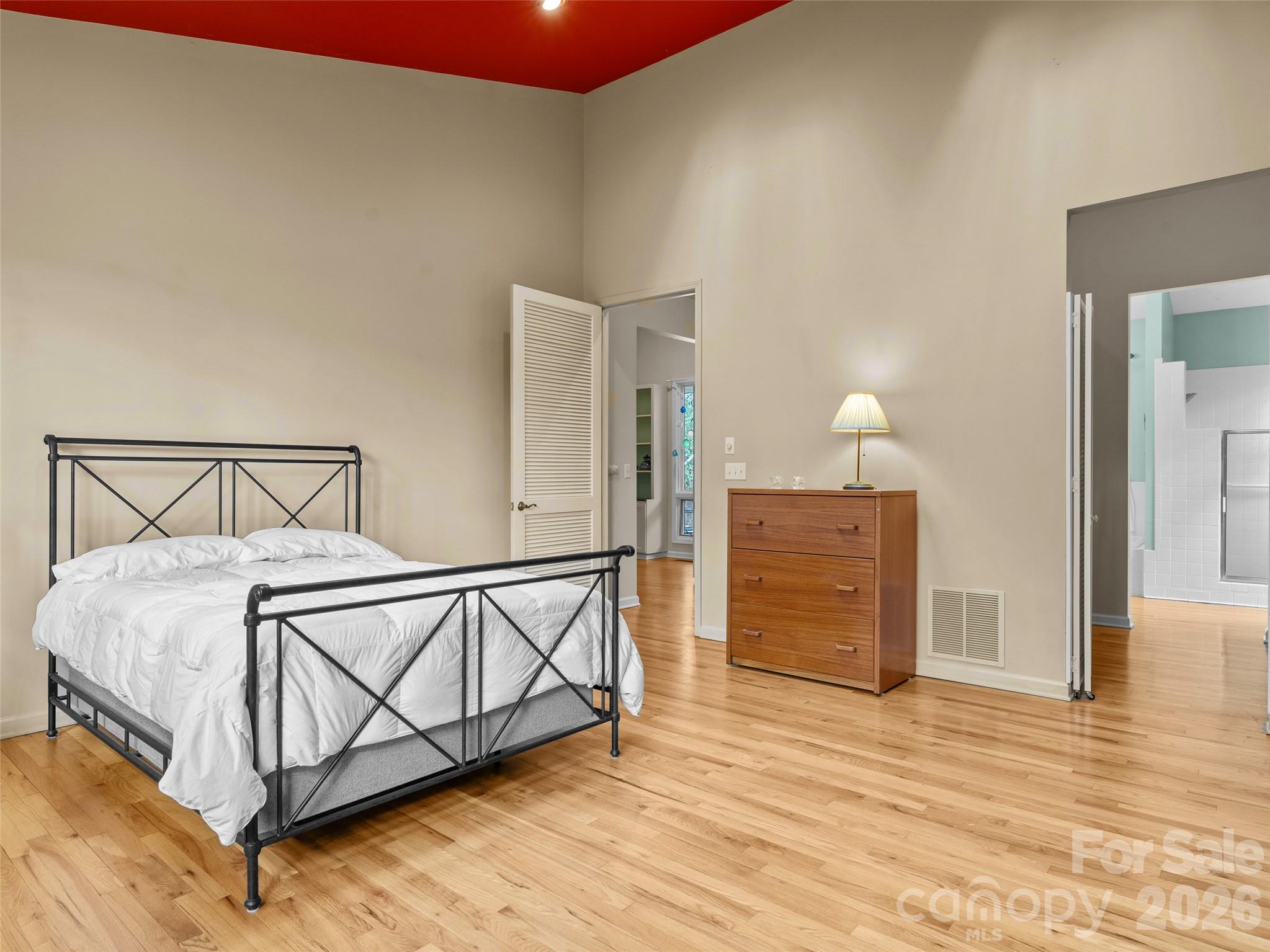 203 Heathcote Road Hendersonville, NC 28791 - Photo 18 of 47 a bedroom with a bed and cabinets