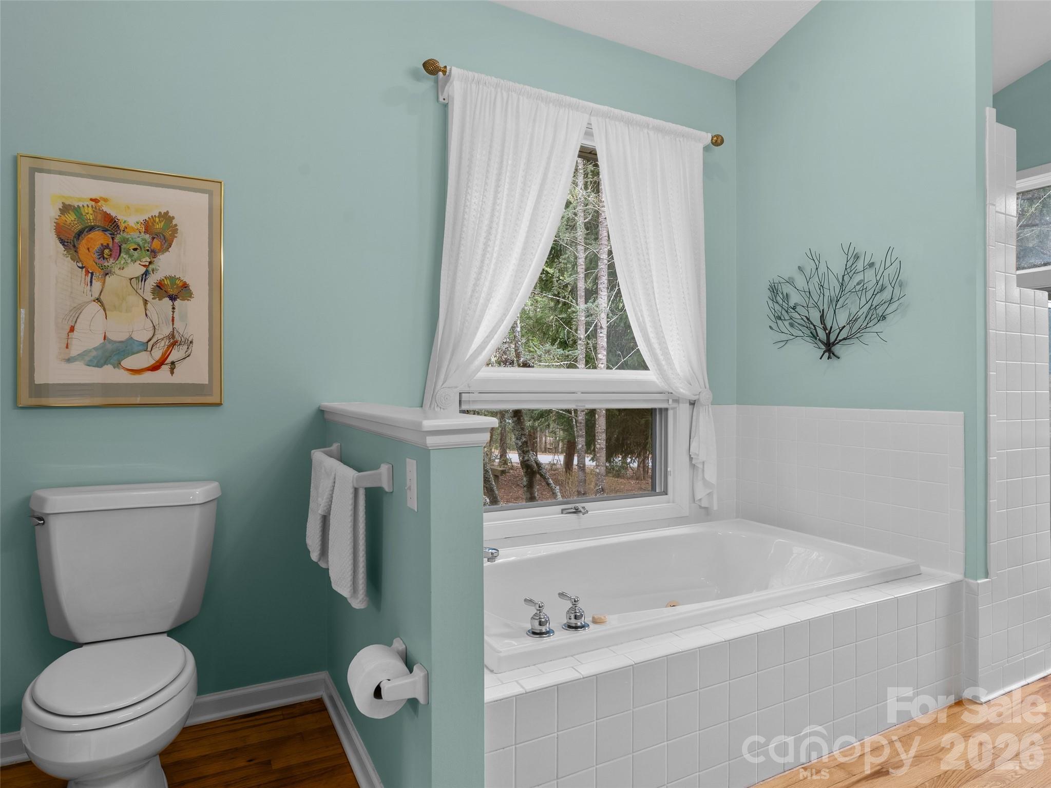 203 Heathcote Road Hendersonville, NC 28791 - Photo 21 of 47 a bathroom with a toilet and a bathtub