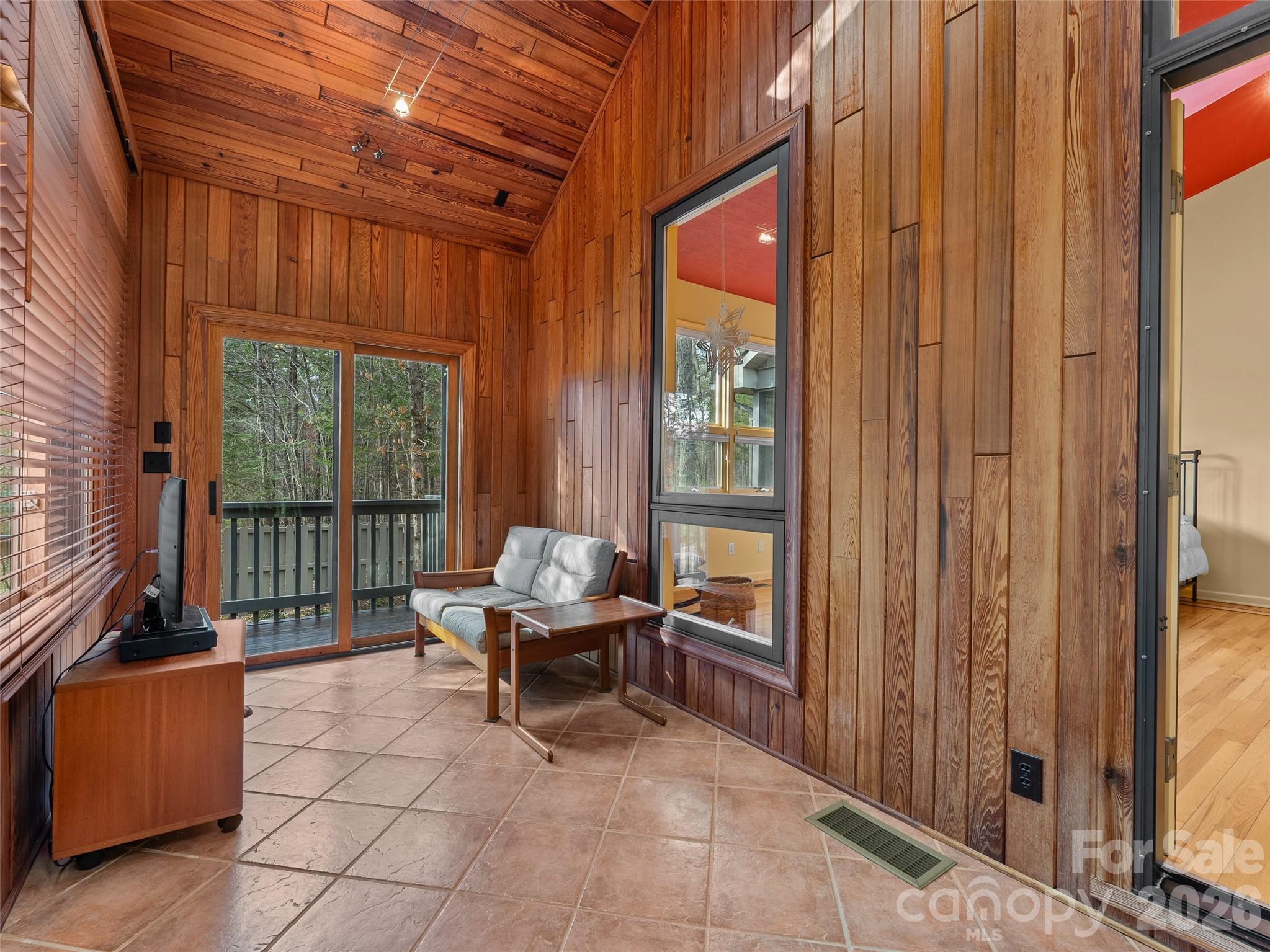 203 Heathcote Road Hendersonville, NC 28791 - Photo 25 of 47 a room with furniture and large windows