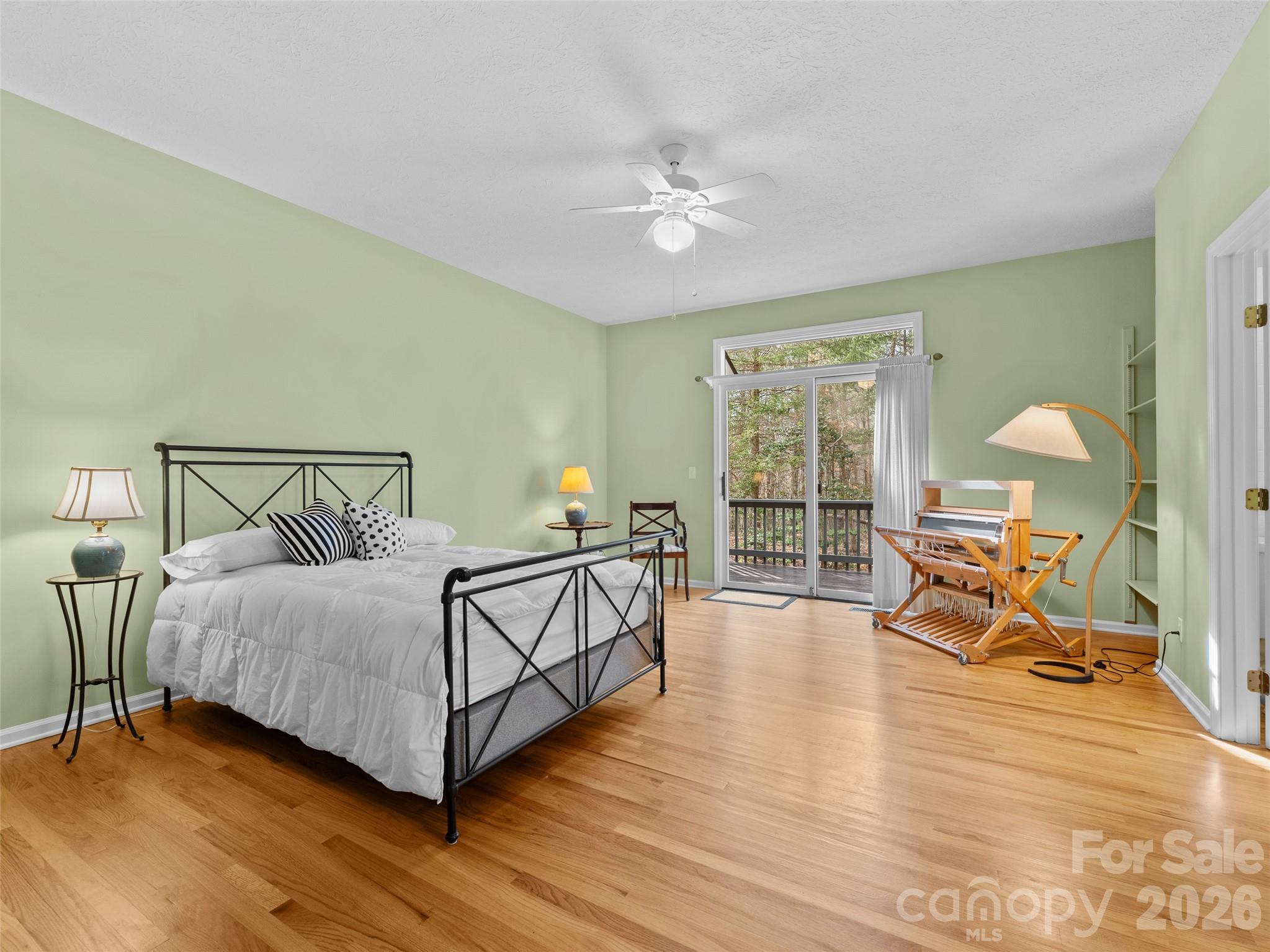 203 Heathcote Road Hendersonville, NC 28791 - Photo 29 of 47 a bedroom with a bed and wooden floor
