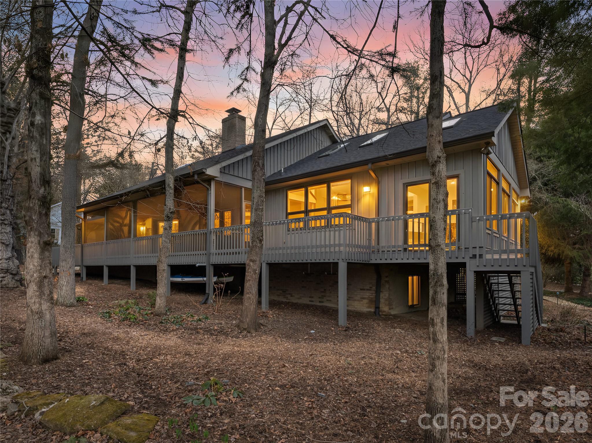 203 Heathcote Road Hendersonville, NC 28791 - Photo 3 of 47 a view of a house with a yard and floor to ceiling window