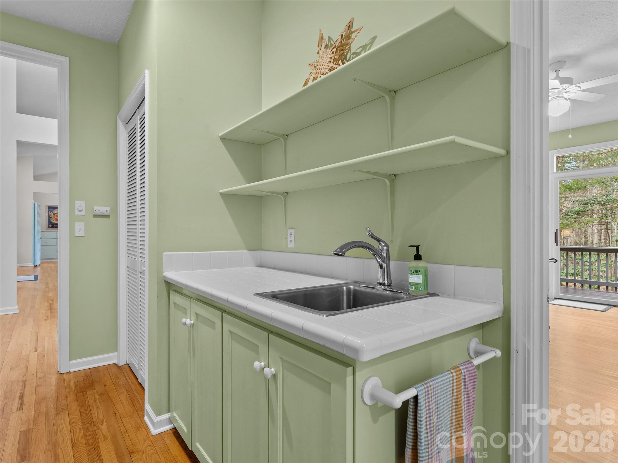 203 Heathcote Road Hendersonville, NC 28791 - Photo 32 of 47 a kitchen with a sink and a refrigerator