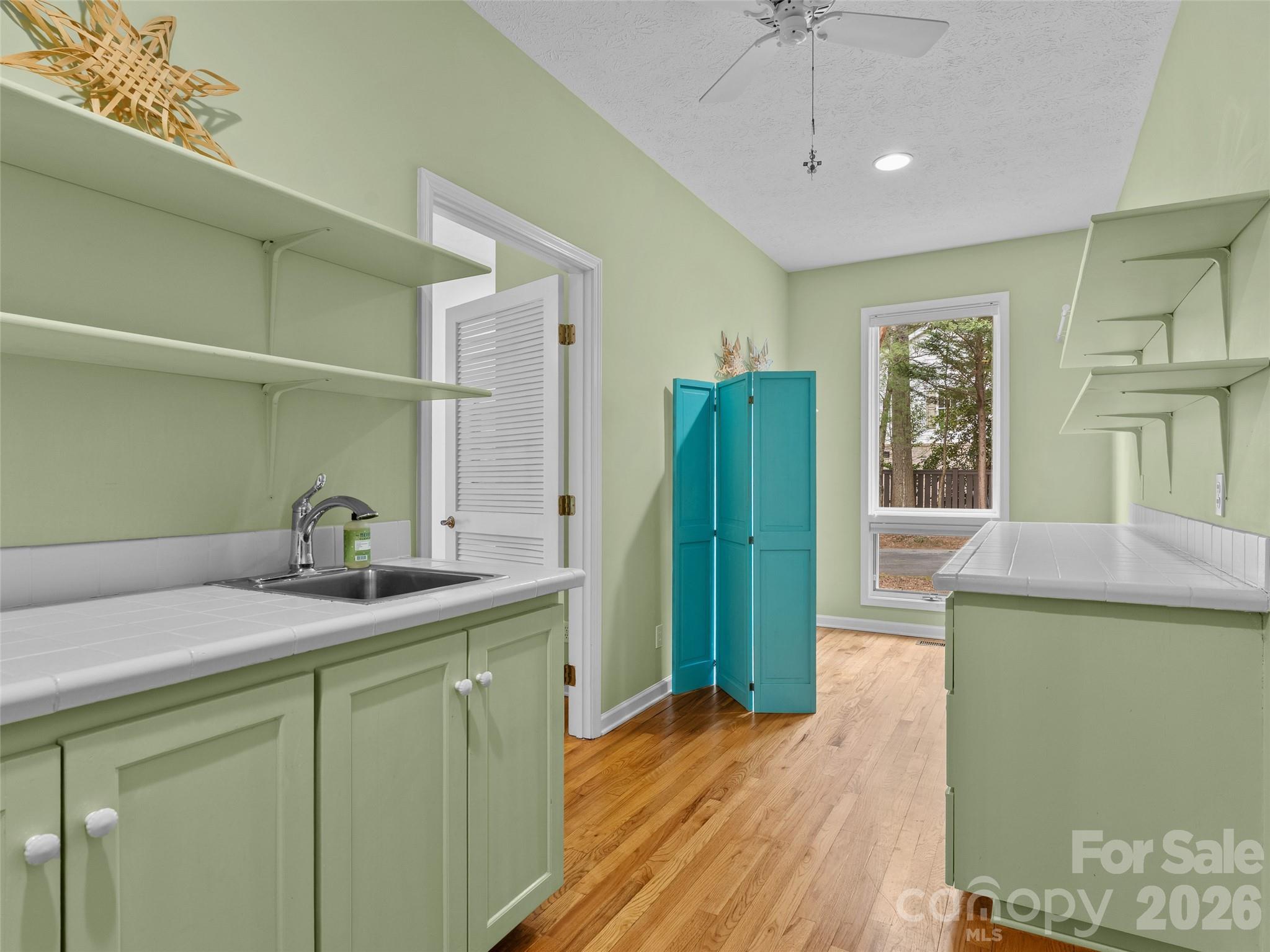 203 Heathcote Road Hendersonville, NC 28791 - Photo 33 of 47 a kitchen with a refrigerator and sink