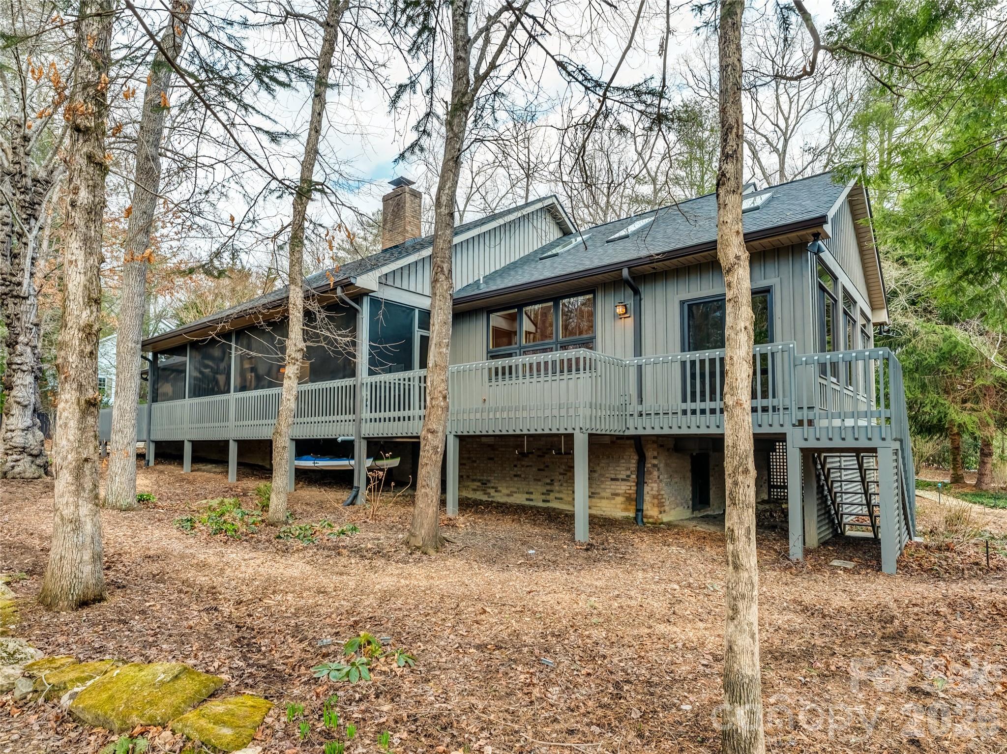 203 Heathcote Road Hendersonville, NC 28791 - Photo 37 of 47 a view of a house with a yard and large tree