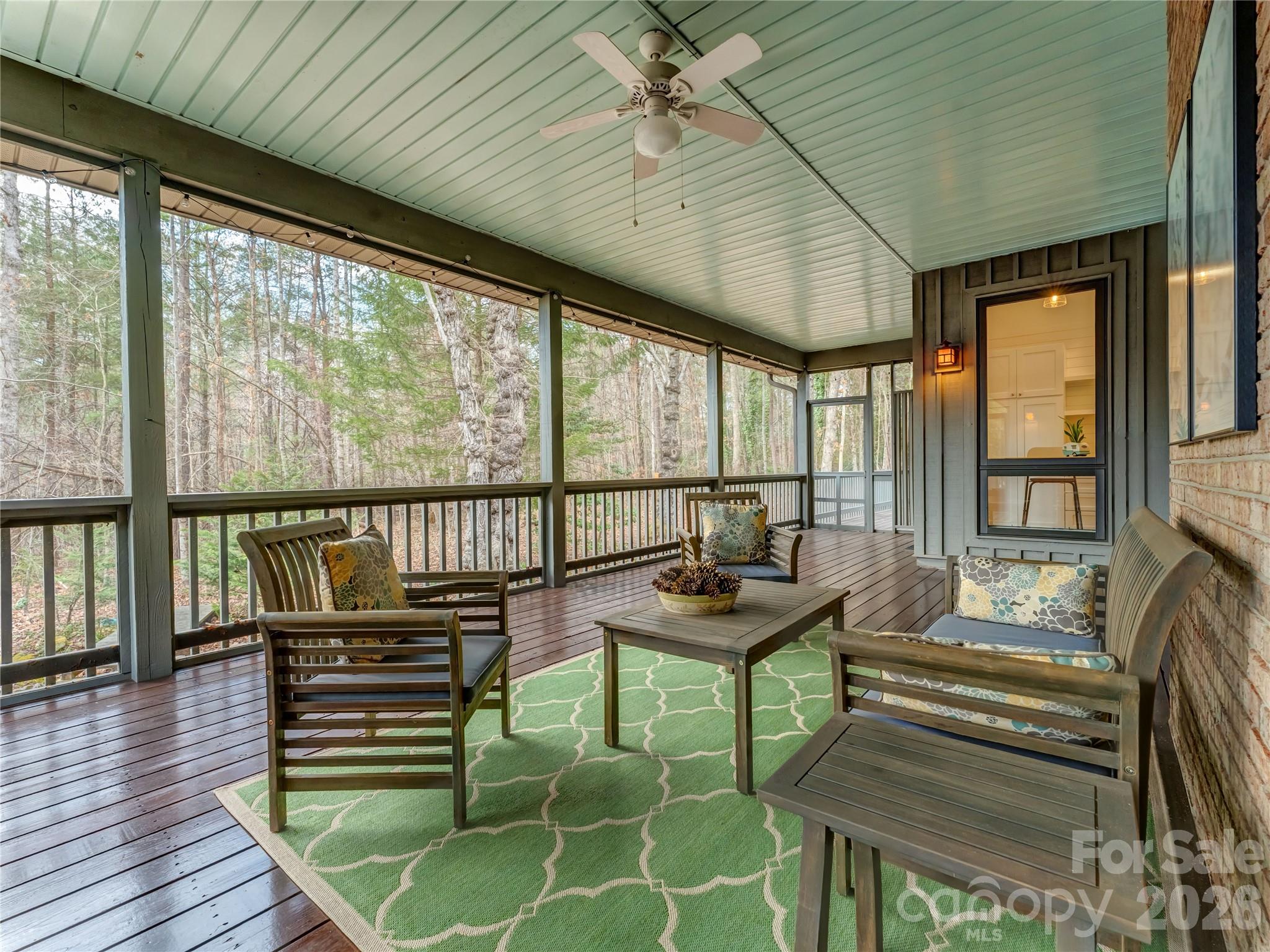 203 Heathcote Road Hendersonville, NC 28791 - Photo 42 of 47 a balcony with chairs and wooden floor