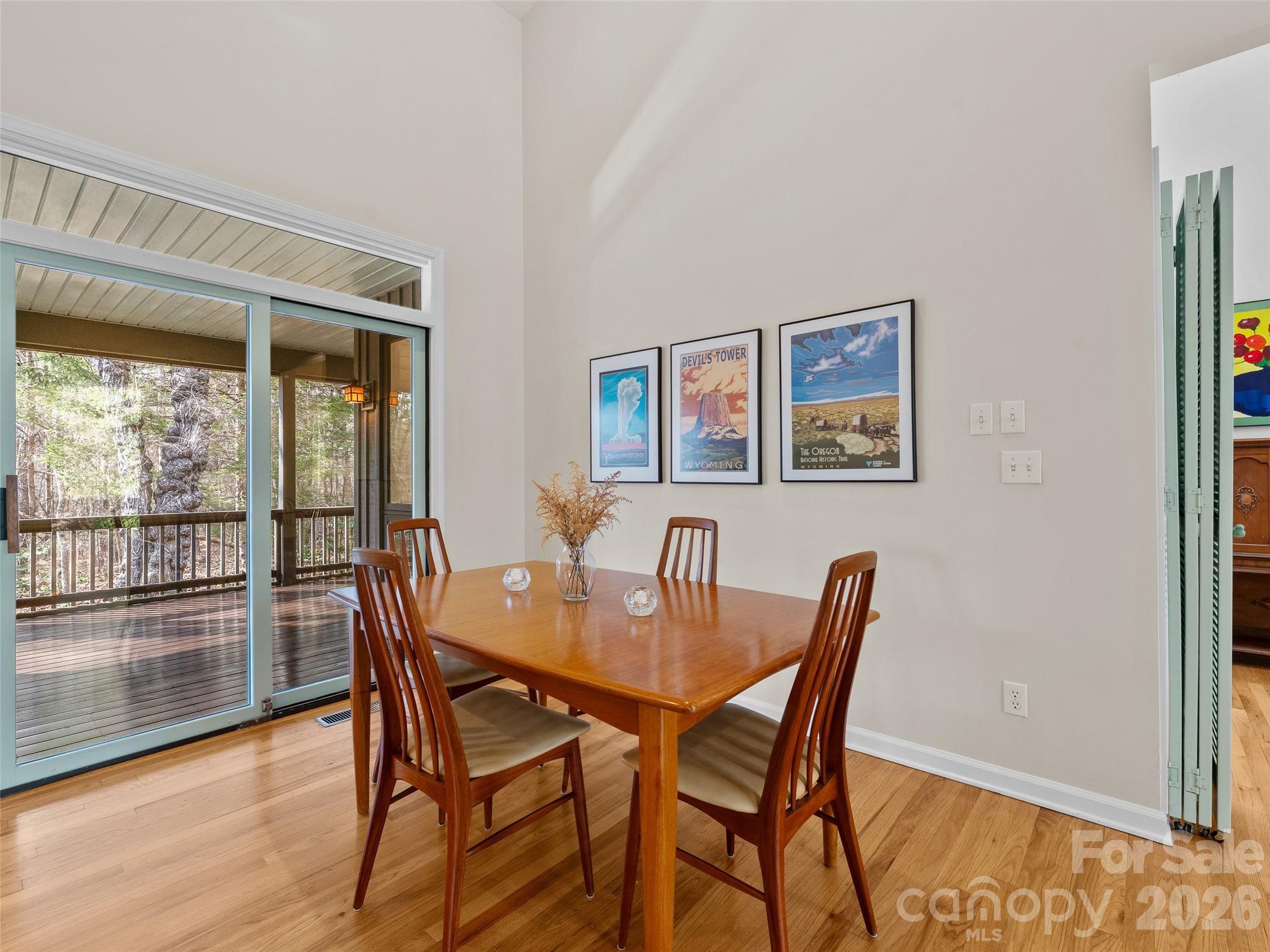 203 Heathcote Road Hendersonville, NC 28791 - Photo 8 of 47 a view of a dining room with furniture wooden floor and a potted plant