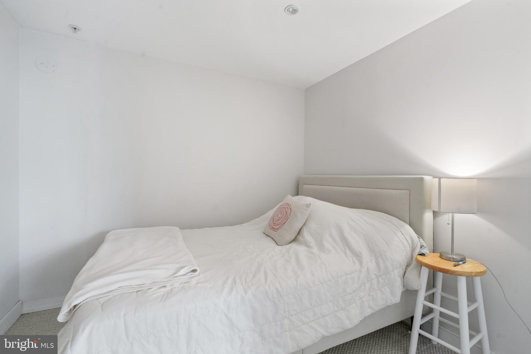 616 E Street Northwest, Unit 304 Washington, DC 20004 - Photo 8 of 53 a bedroom with a bed and a lamp