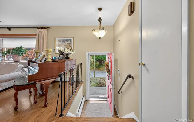 a view of a livingroom with furniture staircase and a chandelier