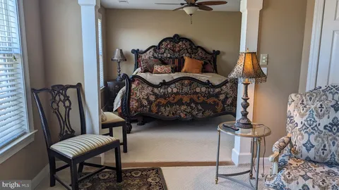a bedroom with furniture and a wooden floor