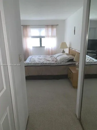 a bathroom with a granite countertop sink and mirror