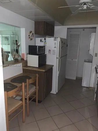 a kitchen with stainless steel appliances a refrigerator and a stove top oven