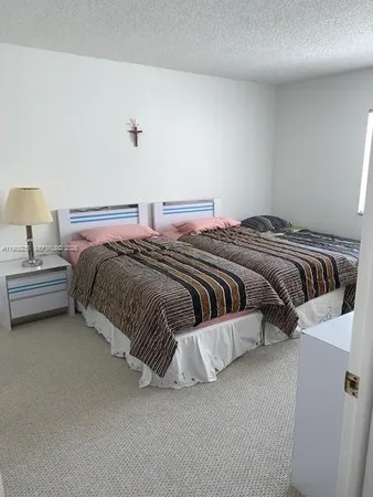 a bedroom with a bed and lamp