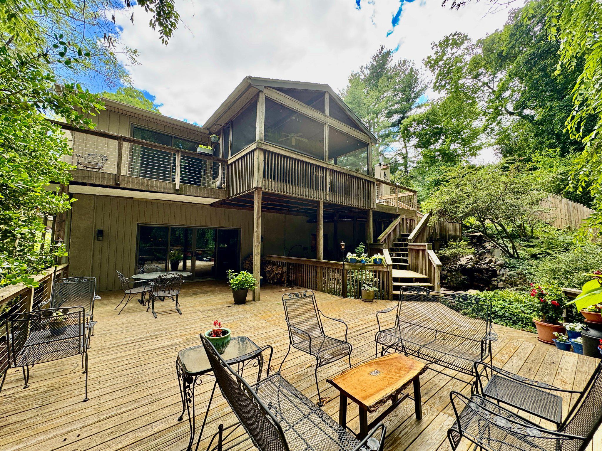 24 Springtree Lane Yardley, PA 19067 - Photo 70 of 84 a view of a patio with couches table and chairs with wooden floor and plants