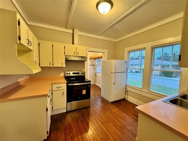 a kitchen with stainless steel appliances a refrigerator and a stove
