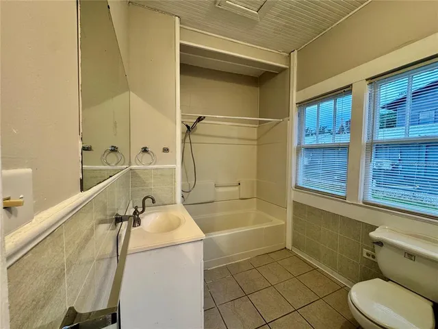 a bathroom with a sink a toilet and bathtub