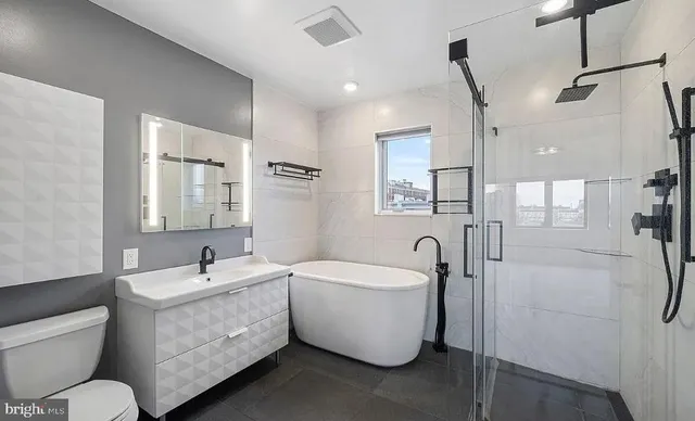 a view of a hallway with white walls and entryway