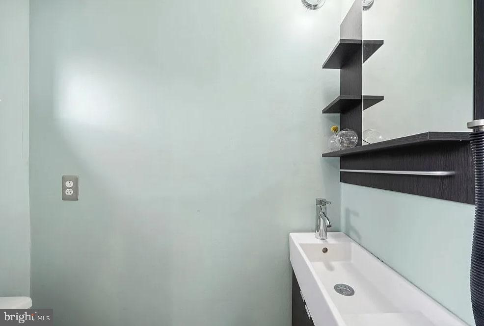 928 Wallace Street Philadelphia, PA 19123 - Photo 18 of 19 a bathroom with a sink and a mirror