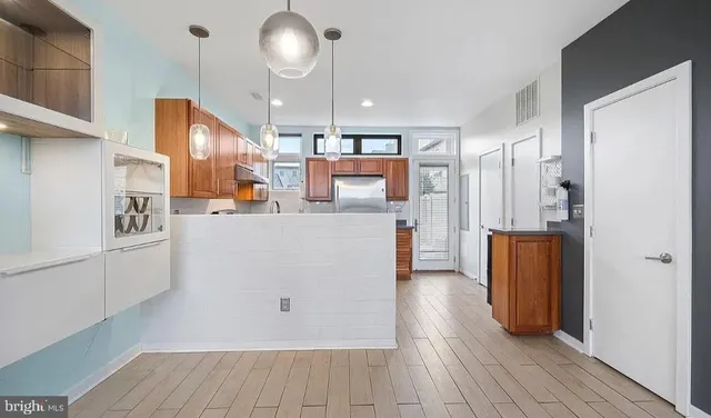 a view of kitchen with cabinets and wooden floor