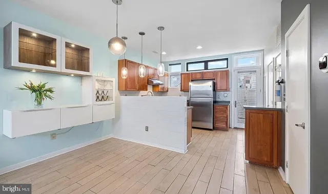 a kitchen with stainless steel appliances granite countertop a refrigerator a sink and a stove