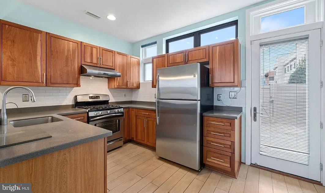 928 Wallace Street Philadelphia, PA 19123 - Photo 4 of 19 a kitchen with granite countertop a refrigerator and a sink