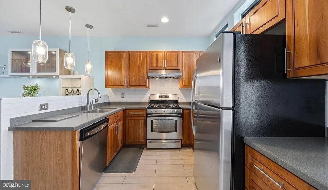 928 Wallace Street Philadelphia, PA 19123 - Photo 5 of 19 a kitchen with stainless steel appliances granite countertop a sink a stove and a refrigerator