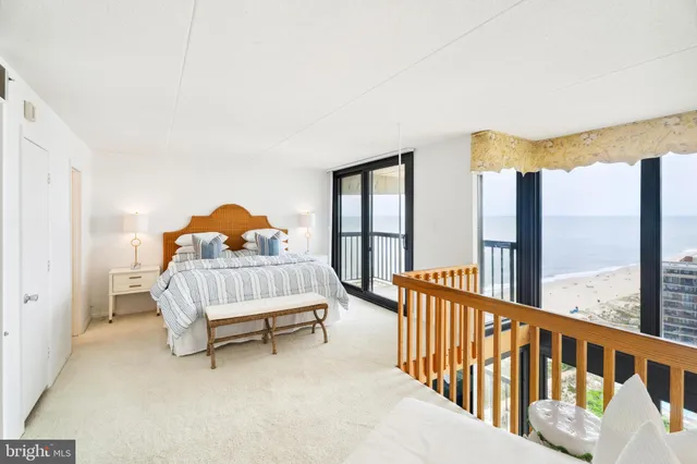 a bedroom with furniture and a large window