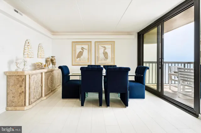 a living room with furniture and large windows