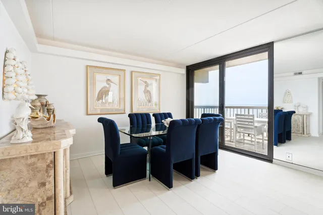 a living room with furniture and large windows