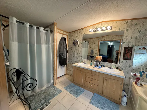 a kitchen with stainless steel appliances kitchen island granite countertop a sink and cabinets