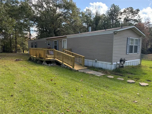 a view of a house with a backyard