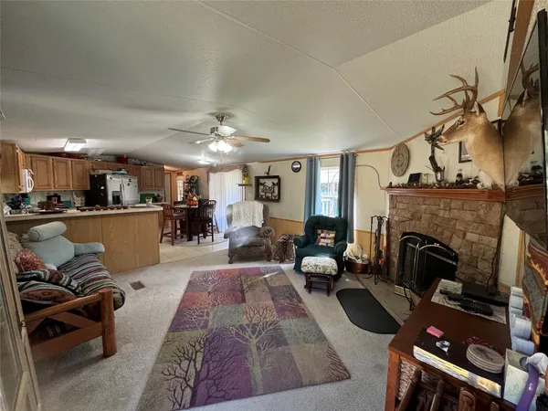 a kitchen with a dining table chairs and a refrigerator