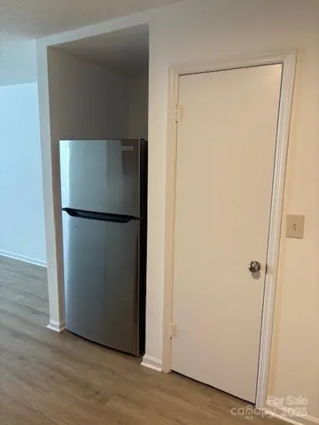 a view of a space with wooden floor and closet