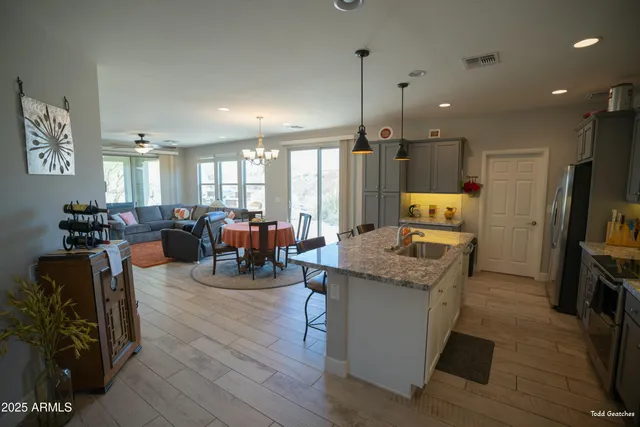 a open kitchen with stainless steel appliances granite countertop a stove and refrigerator