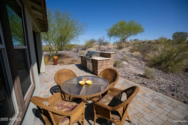 a living room with furniture a ceiling fan and a flat screen tv