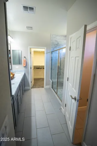 a view of a hallway with wooden floor and a workspace