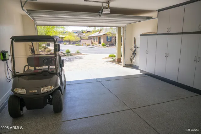 a view of swimming pool with a table and chairs under an umbrella