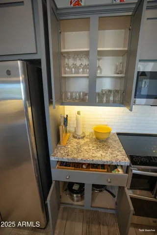 a open kitchen with stainless steel appliances granite countertop a sink a stove and a refrigerator