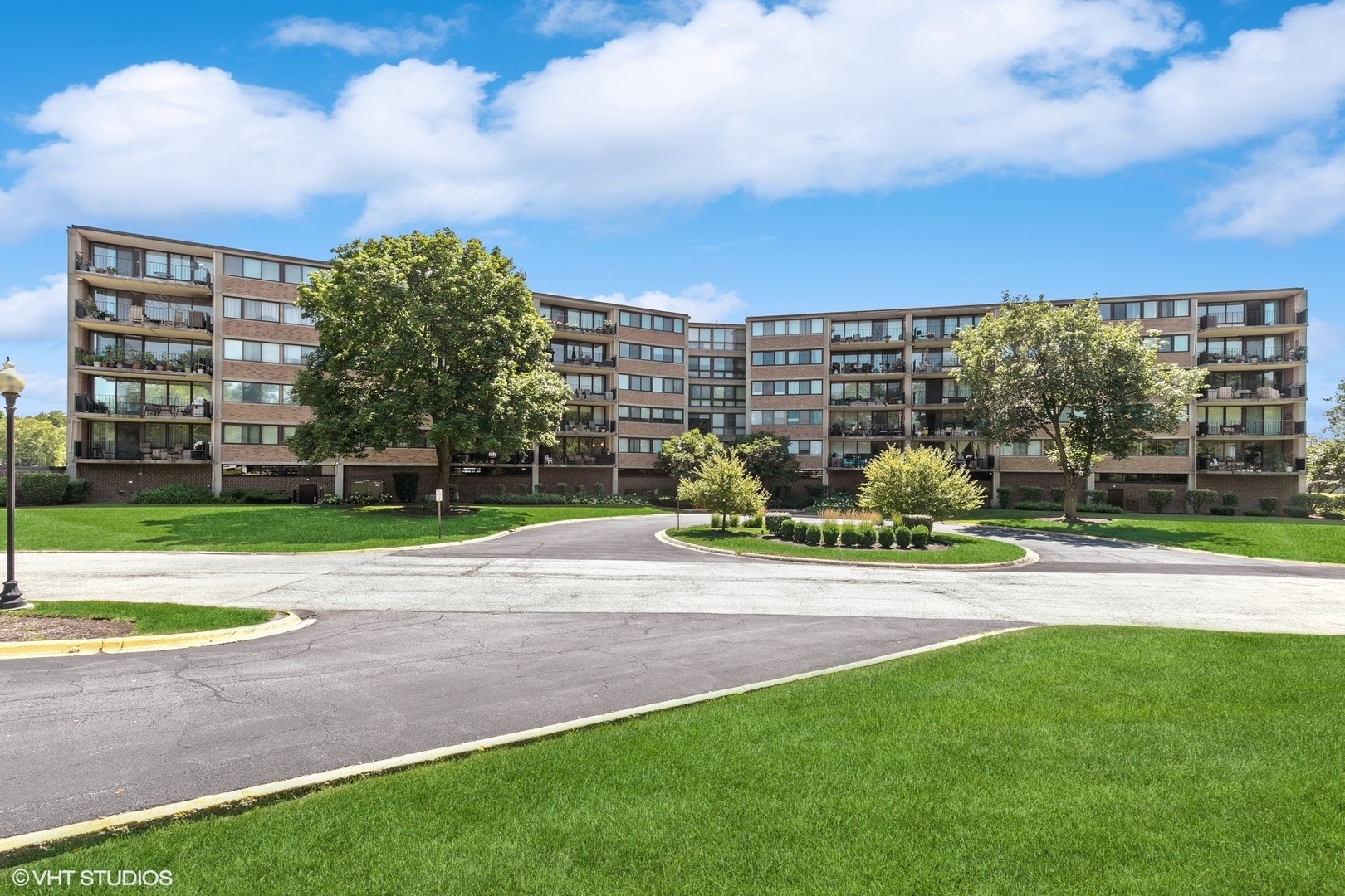 101 Bar Harbour Road, Unit 6D Schaumburg, IL 60193 - Photo 1 of 14 a view of a multi story residential apartment building with a yard